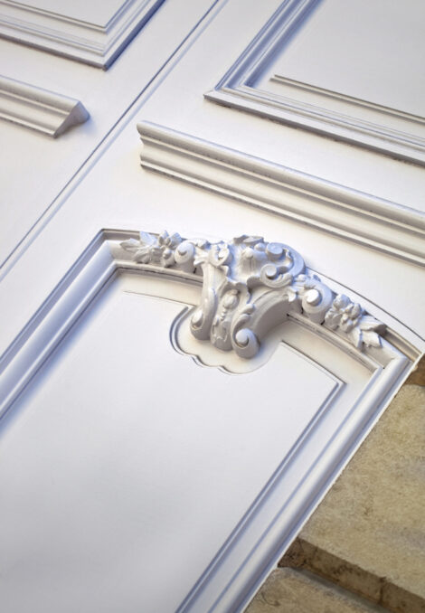 Wooden door on a facade Stylish wooden door on the facade of a French mansion