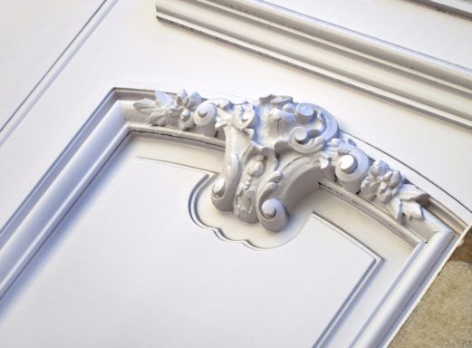 Stylish wooden door on the facade of a French mansion