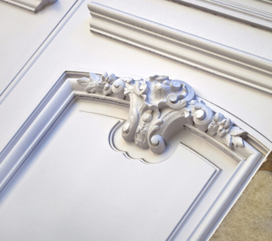 Stylish wooden door on the facade of a French mansion